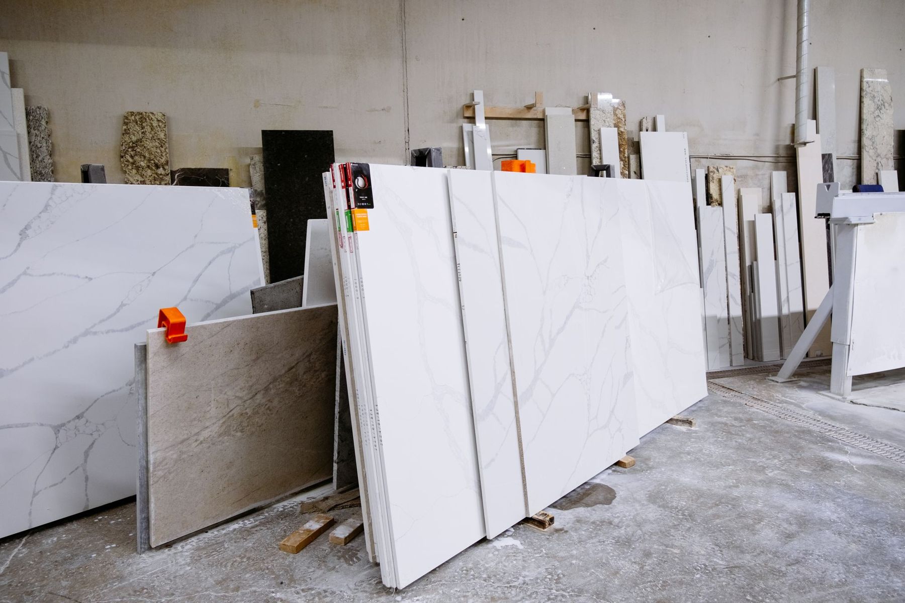 White veined slabs leaning in a stone workshop